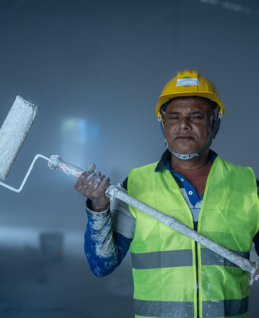 Experienced professional painter holding a paint roller, representing over 10 years of painting expertise in Calgary.