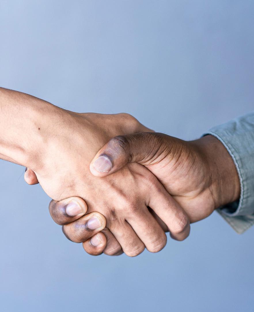 Handshake between a homeowner and a painting professional, symbolizing trusted and respectful painting service in Calgary.